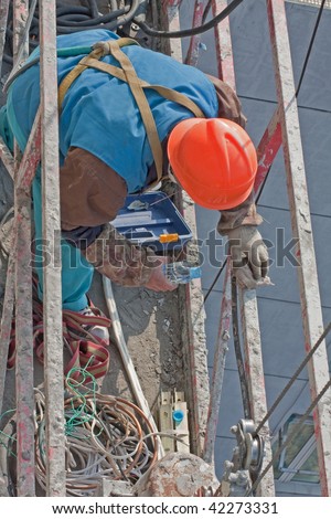 worker cleans a spot on the elevated platform