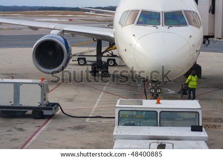 airport worker and parked airplane