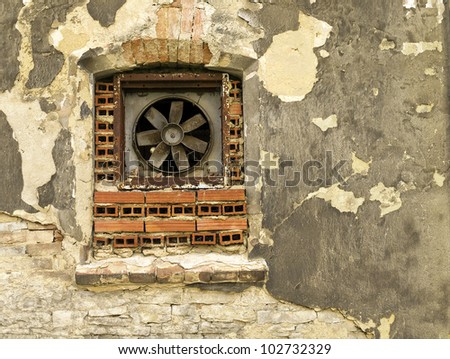 old dirty window as old fan ventilator on old dirty wall