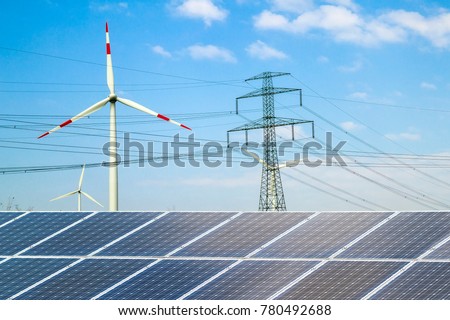 Solar panels against wind turbines. Sustainable development and renewable resources concept.