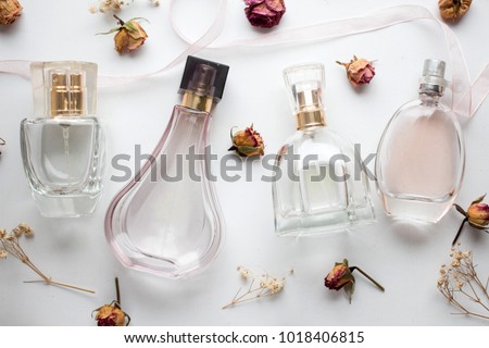 bottle of woman perfume on white background with roses. gift.