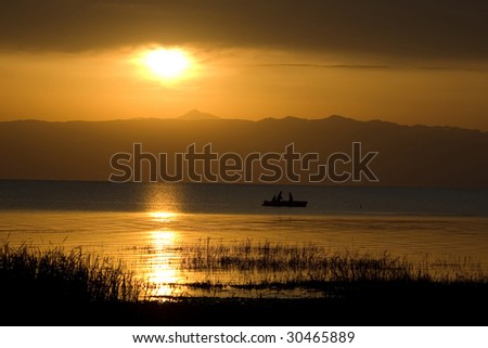 fishermen go fishing on lake early in the morning