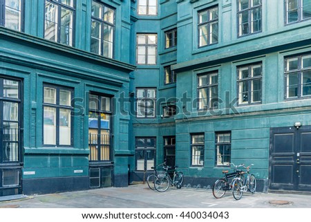 Outdoor view of danish courtyard. Modern architecture. At the yard of beautiful residential house. Yard with parked bicycles. Filled full frame picture.