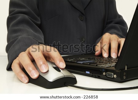 Corporate person using laptop & mouse close up