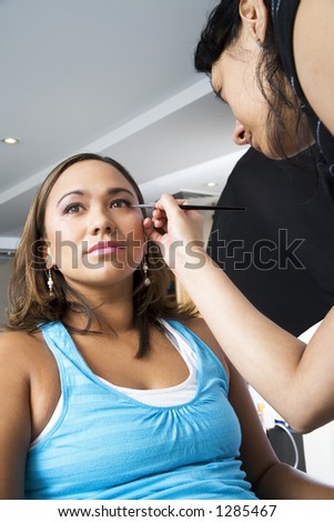 Make up artist applying eye liner