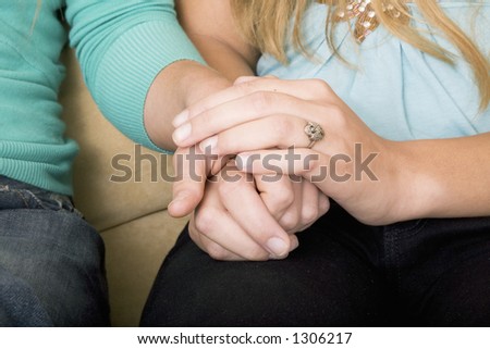 Friends holding hands, emotional support