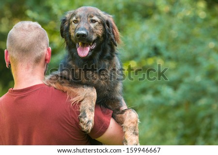 Man carrying his dog