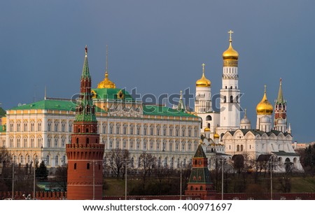 Beautiful view of red brick Moscow kremlin tower with golden church \'s domes and the state kremlin palace in the evening  or sunset of middle spring. Capital of Russia