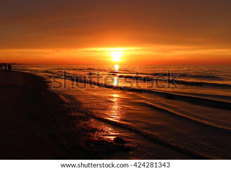 Beautiful landscape of summer sunset or sunrise and evening nature background. Rest on summer beach. Golden summer sunset. Orange summer sunset. Summer time.