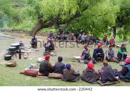 In a Tibetan village in Yunnan,  villagers gather together twice a month at a public open space to chant Buddhist sutras together and to have picnic. Women and men sit on two different sides.