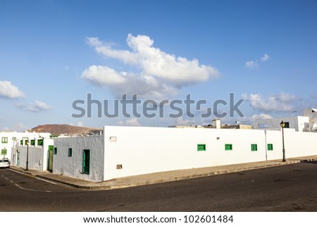 facade of mediterranean house with closed shutterblinds at midday
