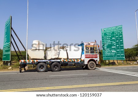 PADANGANJ, INDIA - OCTOBER 21: lorry transports huge marble stones from the pit on highway 7 to resellers all over india on October 21,2012 in Padanganj, india.