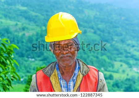 NUWARELIA, SRI LANKA - AUGUST 14: worker at a construction site in the Highlands at a street on August 14, 2005 in Nuwarelia, Sri Lanka. The streets in the jungle suffer under the yearly monsun.