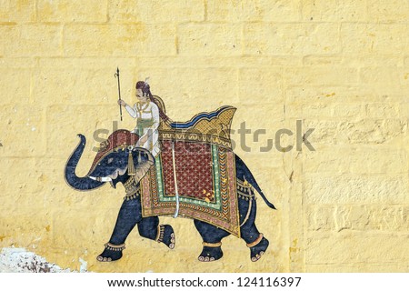 colorful indian mural in the fort at Jodhpur showing a royal procession, including elephant  from the Rajput era