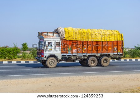 RAJASTHAN, INDIA - OCT 24: cargo transport with truck on highway on Oct 24, 2012 in Rajasthan, India. Roads is the dominant mode of transportation. They carry almost 65 percent of its freight.