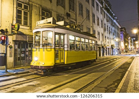 LISBON, PORTUGAL - DECEMBER 29: Traditional yellow tram downtown Lisbon by night on December 29, 2008. Trams are used by everyone and also keep the traditional style of the historic center of Lisbon.