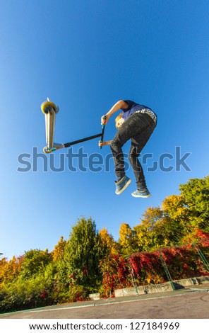 child going airborne with his scooter