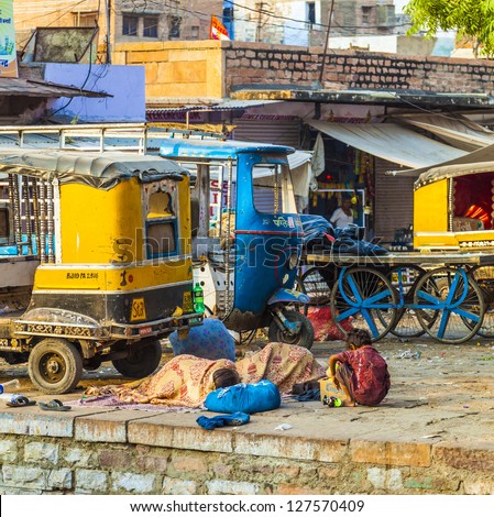 JODHPUR, INDIA - OCT 23: poor people sleep at the street on Oct 23, 2012 in Jodhpur, India. Over 90 million people in India make less than 1 USD per day, setting them below  global poverty threshold.