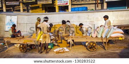DELHI, INDIA - OCT 16: Unidentified workers at Chawri Bazaar have a rest on early morning on October 16,2012 in Delhi, India.They agreed a minimum ages act in 1948, which is in 2011 90 USD or IRP 5000 per month.