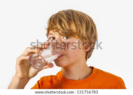 cute boy with orange shirt drinking water