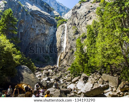 YOSEMITE PARK, USA - JULY 22: tourists cool their legs in the lake of the lower Yosemite waterfall on July 22, 2008 in Yosemite, USA. In 1890, the U.S. Congress declared that area as National park.