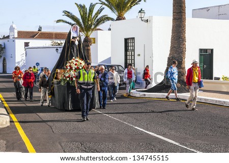 YAIZA, SPAIN - MARCH 30: easter procession with holy Mary on March 30, 2013 in Yaiza, Spain. The centrepiece of every procession is the Virgin Mary who saved Yaiza from the volcanic eruption in 1730.