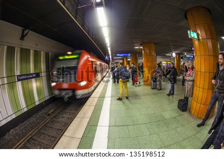 FRANKFURT, GERMANY - APR 12: people wait at the metro station for the arriving train on Apr 12,2013 in Frankfurt, Germany. The Metro station was inaugurated 1978 after 8 years under construction.