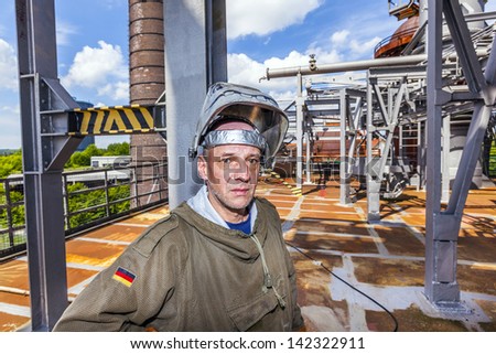 NEUNKIRCHEN, GERMANY - MAY 28: Welder at work at the industry site on May 28,2013 in Neukirchen, Germany. The iron work plant was closed in 1986 and is open now as industry monument for the public.