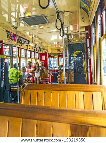 NEW ORLEANS - JULY 15: people travel with the famous old Street car St. Charles line on July 15, 2013 in New Orleans, USA.  It is the oldest continually operating street car line in the world.