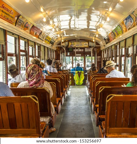 NEW ORLEANS - JULY 17: people travel with the famous old Street car St. Charles line on July 17, 2013 in New Orleans, USA.  It is the oldest continually operating street car line in the world.