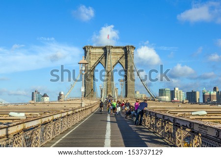 NEW York, USA - July 9: people cross the Brooklyn bridge in late afternoon on July 9,2010, New York. Brooklyn Bridge was constructed under Roebling\'s 1840 patent for the in-situ spinning of wire rope.