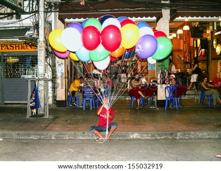 BANGKOK, THAILAND - DECEMBER 03:  Man waits for tourists in Khao San Road to sell balloons  on December 03, 2006 in Bangkok, Thailand. Khao San Road  is one of Bangkok\'s most famous streets.