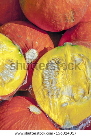 fresh pumpkin cut half and half on the fruit market