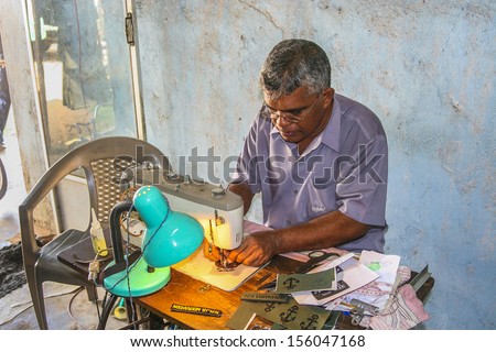 ANURADHAPURA, SRI LANKA JULY 30: sewer at the market is sewing name badges for customers on July, 30, 2005 in Anuradhapura, Sri Lanka.