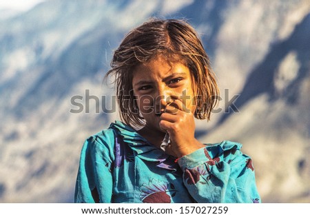 GILGIT, PAKISTAN - Juli 1: portrait of unknown farmer woman on Juli 1, 1988 in Gilgit, Pakistan. People suffer in that area because of the Afghanistan war. She holds some Rupees in her hand.