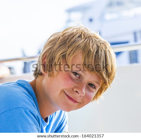 young boy on a boat tour smiles and looks confident