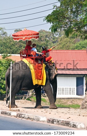 AYUTTHAYA, THAILAND - DEC 24:  tourists on an elefant ride  on December 24, 2009 in Ajutthaja,Thailand. Elephant ride costs 1100 baht per person in the  Ayutthaya Historical Park.