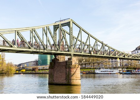 FRANKFURT, GERMANY - MARCH 29: people at Eiserner steg on March 29, 2014 in Frankfurt, Germany. The Eiserner Steg is a pedestrian bridge in Frankfurt am Main built in 1868.