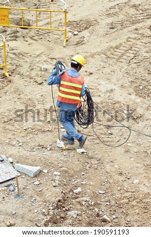 VICTORIA, HONG KONG - JAN 8: worker with electric cable and helmet on Jan 8, 2010 in Victoria, Hong Kong. Helmet and safety west is a must in Hong Kong for workers  and checked by police.