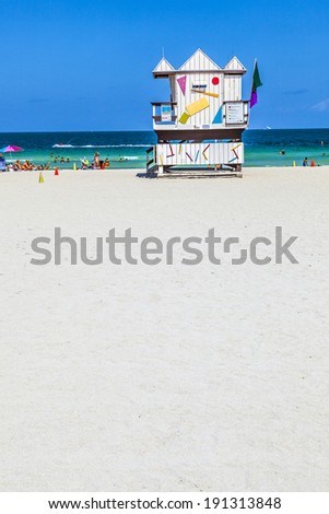 MIAMI, USA - JULY 27: people enjoy beach life on July 27, 2010 in Miami, USA. South beach is famous for its wooden lifeguard towers which are designed in Art deco style.