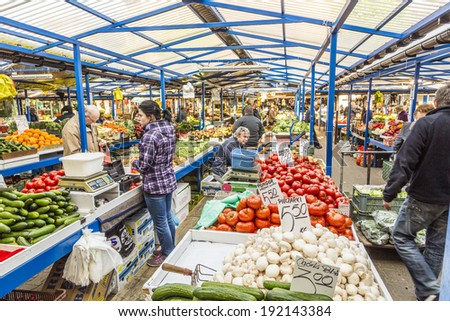 KRAKOW, POLAND - MAY 5, 2014: people sell their goods at the market Stary Kleparz on May 5, 2014 in Krakow, Poland. The covered marketplace has a tradition over 800 years.