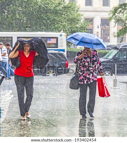NEW YORK, USA - JULY 8, 2010: women in heavy rain in New York. With 100 mm the average railfall the July is the most wet day of a year in New York.