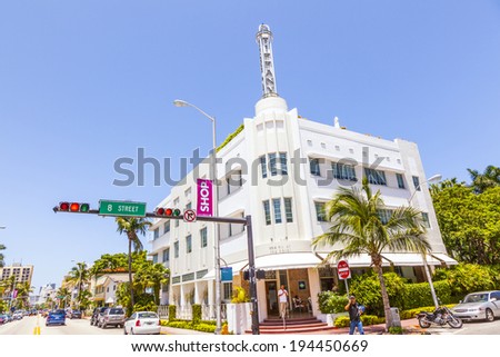 MIAMI, USA - JULY 27, 2010: people in midday heat with facade of art deco building in Miami, USA.  Art Deco architecture in South Beach is one of the main tourist attractions in Miami.