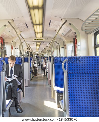 FRANKFURT, GERMANY - MAY 19, 2014: people in the local train Line S3 in Frankfurt, Germany. Frankfurt public transport system is operated by the company RMV. S3 serves the area Frankfurt to Bad Soden.