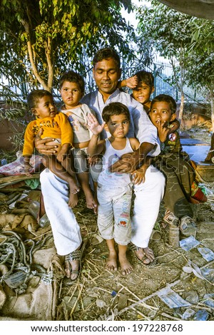 DELHI - INDIA, NOV 8, 2011: proud father shows his children in Delhi, India. In 1952, India launches  a mass media campaign to spread the concept of family planning to reduce population growth.