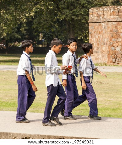 DELHI, INDIA NOV 11, 2011: unidentified school class visits Humayuns tomb in Delhi, India. The boys in school uniform have fun posing for a foto. Schools visit the famous landmarks as part of national education.