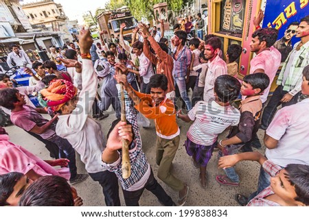 MANDAWA, INDIA - OCT 24, 2012: People throw colors, mostly red, to each other during the Holi celebration in Mandawa, India. Holi is the most celebrated religious color festival in India.