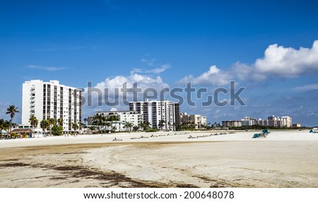 FORT MYERS, USA - JULY 27, 2013: Unknown people on a beach in Fort Myers, USA. Fort Myers first became a nationally known winter resort with the building of the Royal Palm Hotel in 1898.