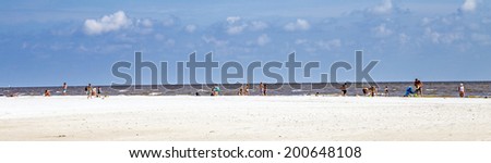 FORT MYERS BEACH, USA - JULY 27, 2013: Unknown people on a beach in Fort Myers Beach, USA. As of the census[  of 2010, there were 6,277 people in 3,444 households residing in the town.