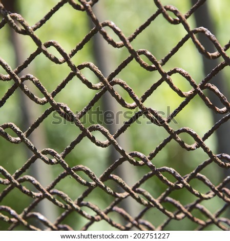 Detail of an old rusting chain link fence